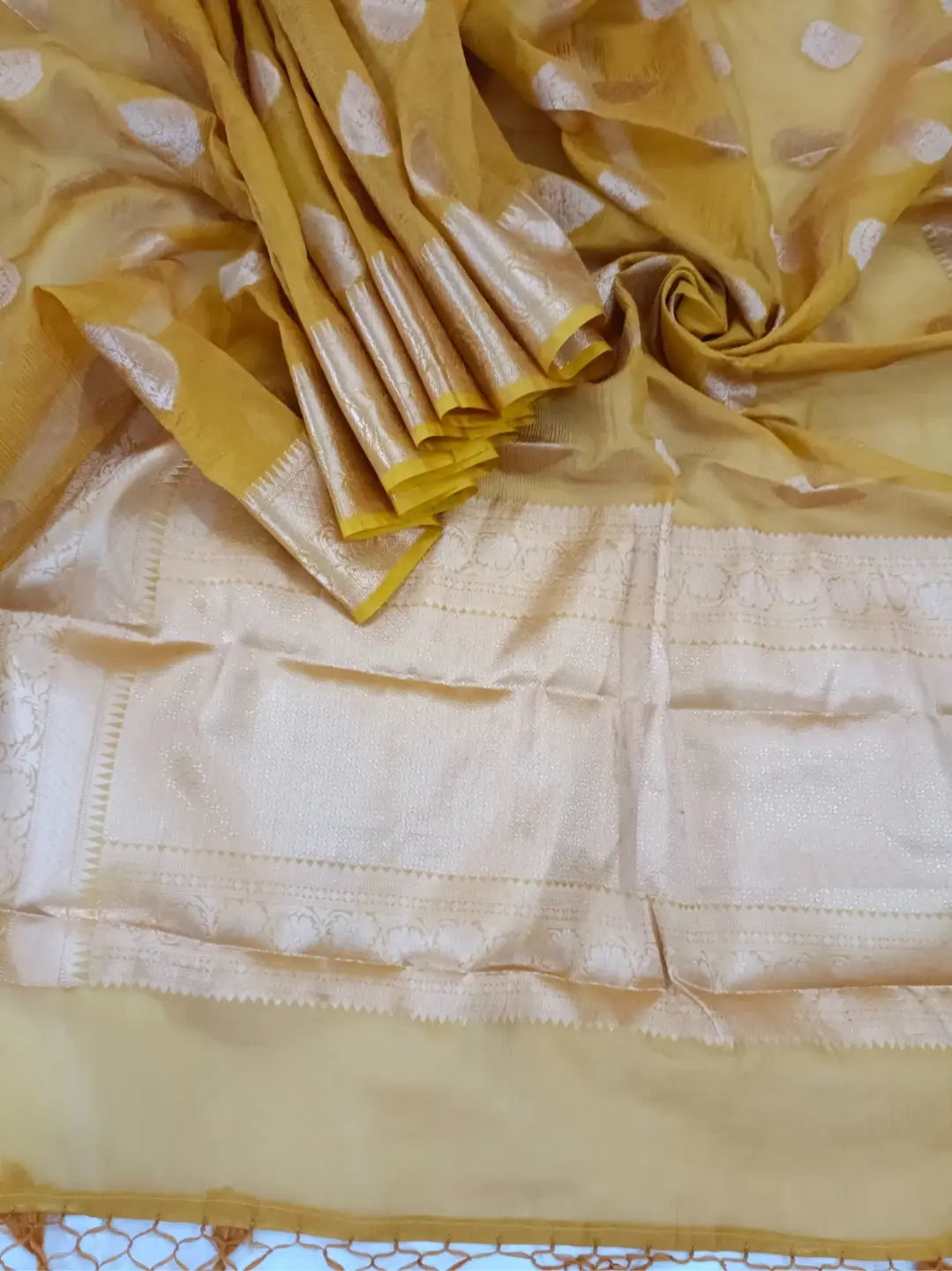 Step into timeless elegance with this stunning Mustard Banarasi Silk Saree
